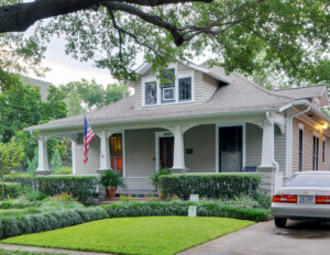 Bungalow style house that has a full front porch along with several column bases, has a dormer on the roof.