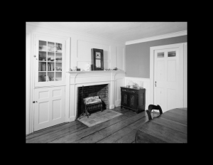 Interior of a cape cod style room featuring cabinetry mouldings and door mouldings.