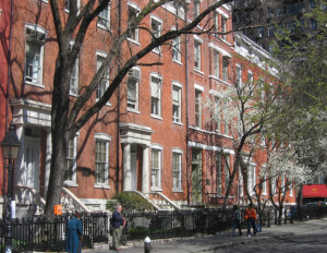 All brick buildings that look like a greek revival style complex featuring pillars and many window mouldings.