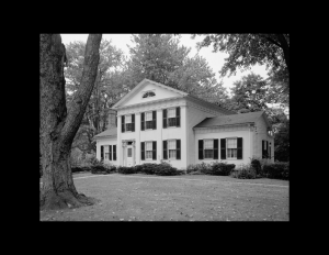 Greek Revival Western Reserve style building featuring double hanging windows, shutters, cornice mouldings, and door mouldings.