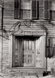 Exterior of Dirlam Allen House showcasing the main doorway featuring door panel molds, and steps to entrance.