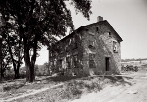 Exterior of Fosdick house featuring all brick walls, window casing mouldings, steps to entrance, door mouldings, and two chimneys.