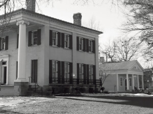 Exterior of Frederick Kinsman Office featuring columns with a covered porch, and shingle siding.