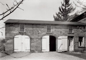 Exterior of Hurst House featuring all brick walls, window mouldings, and oval wooden doors.