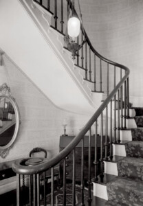 Interior of Martin House featuring staircase with newel post, stair treads, stair balusters, and decorative ornaments.