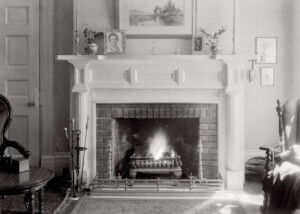 Interior of Martin House fireplace mantel featuring mantel mouldings, column detail, and an all brick fireplace interior.