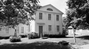 Exterior of Lew Lawyer House with exterior cornice mouldings, and door casing with panel molds, and column detail.