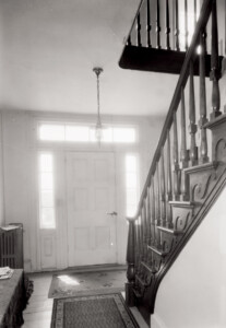 Exterior of Thomas Hurst House featuring staircase railing with molds, door with column detail, panel molds and beautiful ornaments