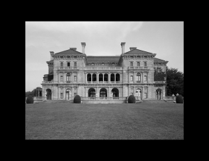 Italian renaissance style castle with low pitched hipped roof, columns, and window mouldings.