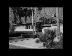 Mid-century modern style house with flat roof and window mouldings.