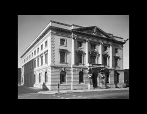 Stone palladian style building featuring cornice mouldings, window mouldings, an interesting design on face of building utilizing pillars.