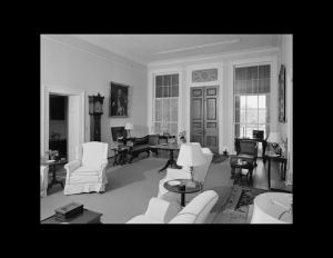 Interior of palladian style house has door mouldings, window mouldings, ceiling mouldings, hardwood floors, and is whitewashed.