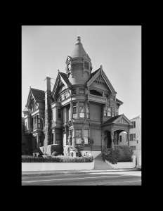 Exterior of building with Victorian style featuring a conical tower, window mouldings, and cornice mouldings.