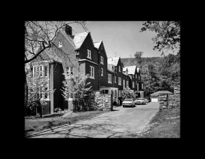 Arts and crafts style houses that are made out of all brick, and are connected to each other forming a housing complex.