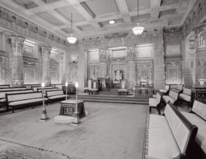 Interior of an egyptian revival style building featuring columns, wall mouldings, and cornice mouldings.