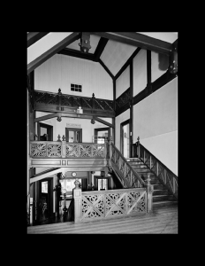 Hardwood staircase leading upstairs in a stick style house featuring ceiling mouldings, and doorway mouldings.