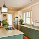 A modern kitchen that uses crown moulding traditionally and as cabinet accents to add depth to the woodwork