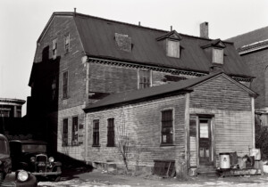 Exterior of side of BENJAMIN PICKMAN HOUSE featuring shingle siding, gable dormers, slanted roof, and window casing mouldings.