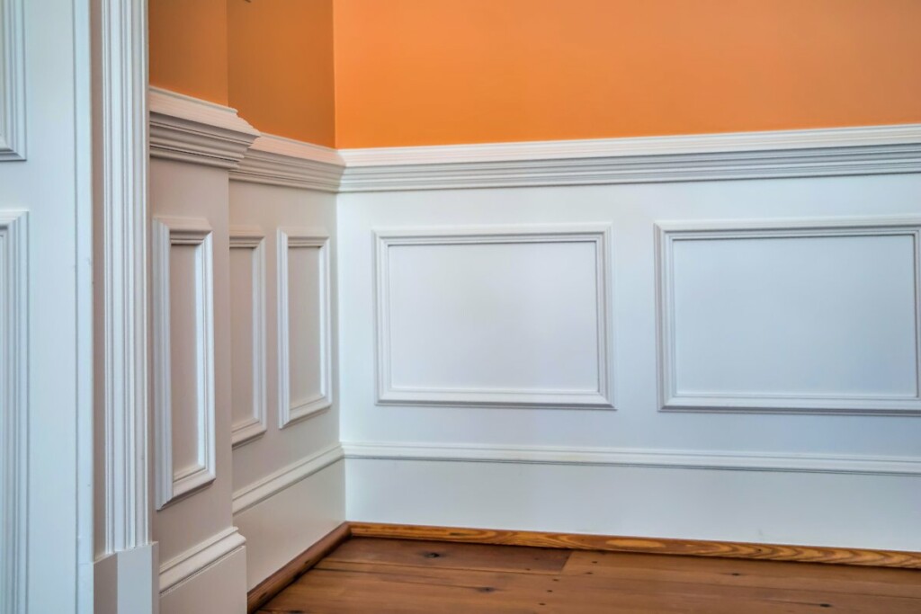 A white chair rail accenting a warm hued wall