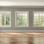 An empty room which features mouldings around the windows and doors