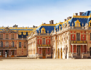 Louis XIV style mansion featuring beautiful color contrast, dormers, ornaments next to window casing mouldings, and door casing mouldings.