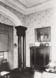 Davenport House North and South Living room ends with arch, wood columns and cornice. Ornament details line the ceiling.