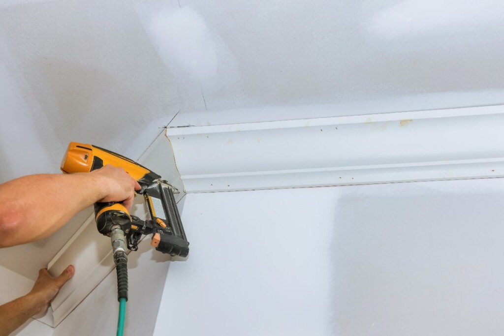 Contractor installing crown molding in a historic home